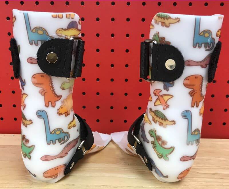 Custom ankle foot orthoses with a dinosaur print, by Applied Biomechanics. 