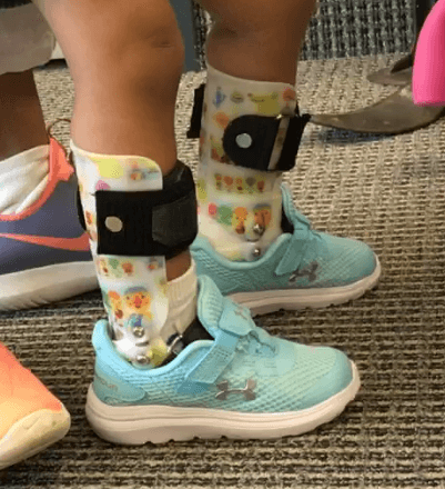 Alt text: A child wearing custom ankle foot orthoses by Applied Biomechanics. 